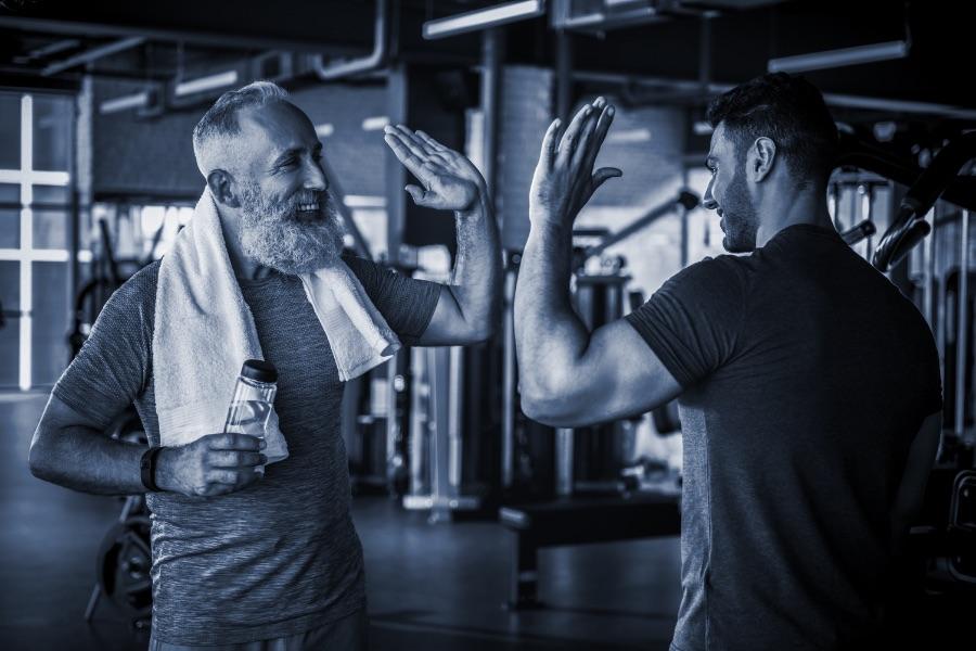 A trainer and their client high-fiving each other.